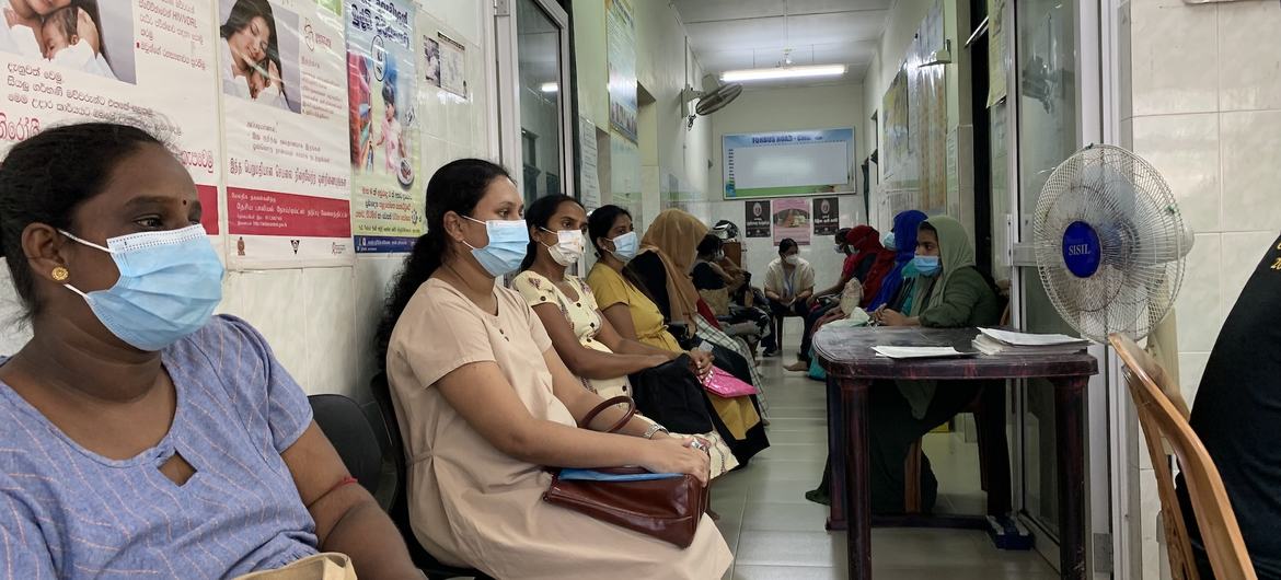 Pregnant women wait to receive food stamps being distributed through WFP's emergency food assistance program. 