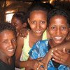 A group of smiling Eritrean women and a young boy posing for a photo.