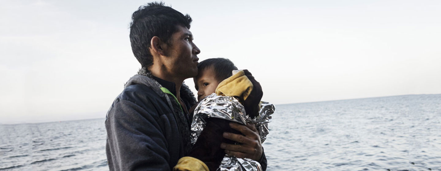 A young refugee from Afghanistan holds his young son and looks at the sea after reaching safely the shores of Lesbos island, having crossed the Aegean sea from Turkey in an inflatable boat full of Afghan refugees (file) A young refugee from Afghanistan holds his young son and looks at the sea after reaching safely the shores of Lesbos island, having crossed the Aegean sea from Turkey in an inflatable boat full of Afghan refugees (file)