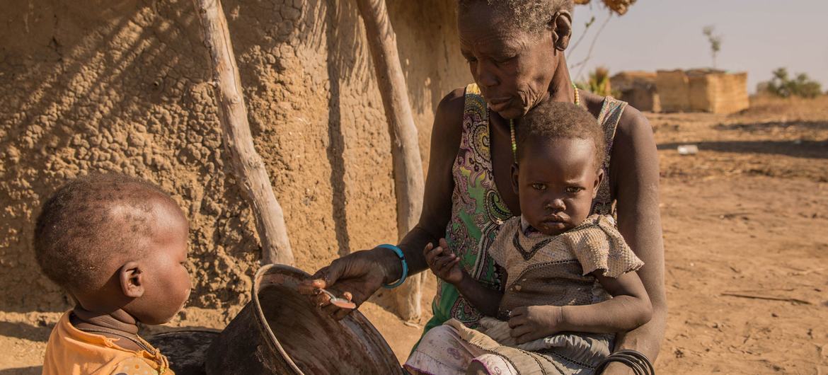 A mother giving sorghum porridge to her children. A growing number of children in South Sudan’s Northern Bahr el Ghazal and Warrap have only one meal per day. A mother giving sorghum porridge to her children. A growing number of children in South Sudan’s Northern Bahr el Ghazal and Warrap have only one meal per day.